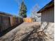 Fenced backyard featuring an additional gate entrance to the yard and gravel at 992 Toledo St, Aurora, CO 80011