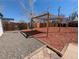 Landscaped backyard features a gravel, mulch and a pergola for outdoor enjoyment at 992 Toledo St, Aurora, CO 80011