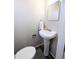 Powder room features a pedestal sink, mirror and a light grey wall color at 992 Toledo St, Aurora, CO 80011