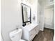 Bathroom with a white vanity, modern fixtures, and a large mirror reflecting the bright, clean space at 992 Toledo St, Aurora, CO 80011