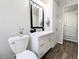 Well-lit bathroom with modern vanity, hardware, and a glimpse into the hallway at 992 Toledo St, Aurora, CO 80011