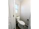 Cozy powder room features a toilet, a window and clean white paint at 992 Toledo St, Aurora, CO 80011