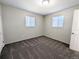 Bedroom with neutral walls, plush carpet, and natural light from two windows at 992 Toledo St, Aurora, CO 80011