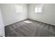 Bright, carpeted bedroom with neutral walls and natural light coming through two windows at 992 Toledo St, Aurora, CO 80011