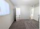 Bedroom featuring neutral walls, carpet, and two doors, one leading to the ensuite bathroom at 992 Toledo St, Aurora, CO 80011