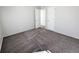 Bedroom with neutral walls and carpet; featuring a doorway leading to another room at 992 Toledo St, Aurora, CO 80011