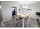 Dining room with rustic table, white chairs and view into the kitchen at 992 Toledo St, Aurora, CO 80011