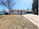 Charming home featuring a well-maintained lawn, a driveway, and a covered carport at 992 Toledo St, Aurora, CO 80011