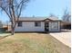 Charming single-story home featuring a well-manicured front yard and attached carport at 992 Toledo St, Aurora, CO 80011