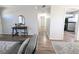 Hallway with wood floors, neutral walls, and a peek into the kitchen at 992 Toledo St, Aurora, CO 80011