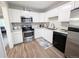 Bright kitchen features stainless steel appliances, white cabinets, and granite countertops at 992 Toledo St, Aurora, CO 80011