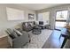 Cozy living room with a gray sectional, stylish rug, and abundant natural light at 992 Toledo St, Aurora, CO 80011