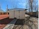 Exterior of a shed with a wood fence, mulch and a stone pathway at 992 Toledo St, Aurora, CO 80011