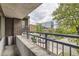 Condo balcony with city views, brick exterior, and metal railing at 830 N Sherman St # 208, Denver, CO 80203
