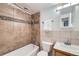 Bathroom with neutral tiles, a shower and tub combo, and built in vanity at 830 N Sherman St # 208, Denver, CO 80203