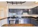 Well-lit kitchen features stainless steel appliances, dark granite countertops, and ample cabinet space at 830 N Sherman St # 208, Denver, CO 80203