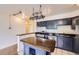 View of the updated kitchen, featuring countertops, a cooktop, and kitchen island at 830 N Sherman St # 208, Denver, CO 80203
