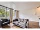 Bright living room features wood floors, large windows, and comfortable seating at 830 N Sherman St # 208, Denver, CO 80203