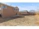 Spacious backyard featuring a small patio area and wooden fence, perfect for outdoor activities at 16643 E 101St Ave, Commerce City, CO 80022