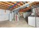 Basement with utilities including a water heater and laundry equipment at 16643 E 101St Ave, Commerce City, CO 80022