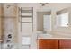 Bathroom featuring a shower-tub combo with tile, a toilet, vanity and mirrored wall cabinet at 16643 E 101St Ave, Commerce City, CO 80022