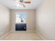 Bright bedroom features neutral walls, carpet, a ceiling fan, and a window providing natural light at 16643 E 101St Ave, Commerce City, CO 80022