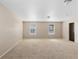 Bedroom featuring two windows offering natural light and carpeted flooring at 16643 E 101St Ave, Commerce City, CO 80022