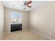 Carpeted bedroom with ceiling fan, single window with blind, and dark accent wall at 16643 E 101St Ave, Commerce City, CO 80022