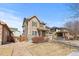 Charming two-story home with a stone facade and covered porch in a residential neighborhood at 16643 E 101St Ave, Commerce City, CO 80022