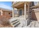 Charming front porch with stone accents and a covered entrance, providing a welcoming curb appeal at 16643 E 101St Ave, Commerce City, CO 80022