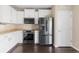 Well-equipped kitchen featuring stainless steel appliances and white cabinetry at 16643 E 101St Ave, Commerce City, CO 80022