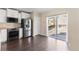 Well-lit eat-in kitchen with sliding doors, modern appliances, and white cabinets at 16643 E 101St Ave, Commerce City, CO 80022