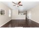 Spacious living room with hardwood floors, neutral paint, ceiling fan, and lots of natural light at 16643 E 101St Ave, Commerce City, CO 80022