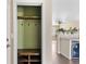 Mud room featuring a bench and coat rack, seamlessly flowing into the kitchen area at 16643 E 101St Ave, Commerce City, CO 80022