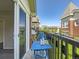 Cozy balcony with a blue table set and neighborhood views at 30 Garfield St # B, Denver, CO 80206