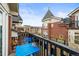 Charming balcony with blue table set and views of the neighborhood's unique architecture at 30 Garfield St # B, Denver, CO 80206