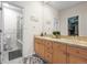 Lovely bathroom featuring double sinks, a tiled shower, and access to a walk-in closet at 30 Garfield St # B, Denver, CO 80206