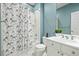 Bright bathroom featuring white vanity, blue walls, and a shower with penguin curtain at 30 Garfield St # B, Denver, CO 80206
