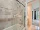 Bright and clean bathroom featuring a glass enclosed tub and shower with tiled walls at 30 Garfield St # B, Denver, CO 80206