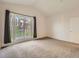 Bright, carpeted bedroom featuring large windows offering ample natural light and a private balcony at 30 Garfield St # B, Denver, CO 80206