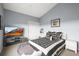 Stylish bedroom with a patterned bedspread, TV, and neutral walls at 30 Garfield St # B, Denver, CO 80206