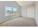 Carpeted bedroom with natural light, featuring two bright windows and a double-door closet at 30 Garfield St # B, Denver, CO 80206