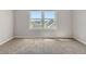 Bright, carpeted bedroom with two windows providing ample natural light and neighborhood views at 30 Garfield St # B, Denver, CO 80206