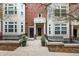 Charming townhome exterior with a landscaped front yard, brick facade, and inviting entrance at 30 Garfield St # B, Denver, CO 80206