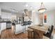 Open concept kitchen and dining area with stainless steel appliances, breakfast bar, and hardwood floors at 30 Garfield St # B, Denver, CO 80206