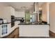 Bright kitchen boasts stainless appliances, granite countertops, and a large center island with cooktop at 30 Garfield St # B, Denver, CO 80206
