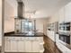 Open kitchen with granite counters, stainless appliances, and a breakfast bar that overlooks a cozy balcony at 30 Garfield St # B, Denver, CO 80206