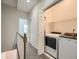 Hallway with a laundry room featuring modern appliances and shelving at 30 Garfield St # B, Denver, CO 80206
