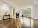 Large living room with fireplace, built-in shelving, gleaming wood floors and bright bay windows at 30 Garfield St # B, Denver, CO 80206
