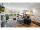 Living room with a fireplace, large windows, hardwood floors, and comfortable seating area at 30 Garfield St # B, Denver, CO 80206